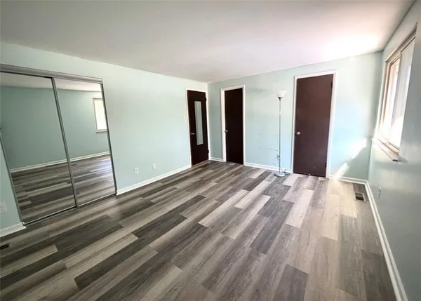 a bedroom with a bed and a mirror