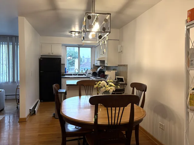 a view of a dining room with furniture a chandelier and wooden floor