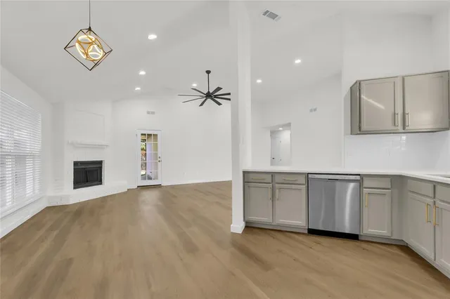 a view of an empty room with a window and fireplace