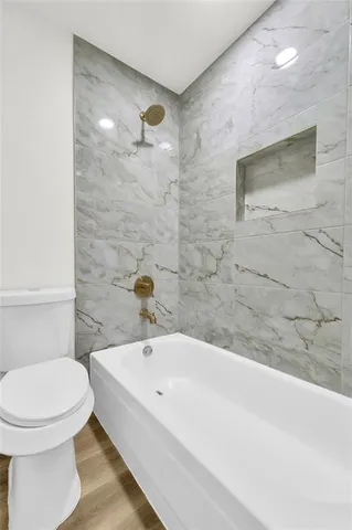a bathroom with a bathtub and a toilet