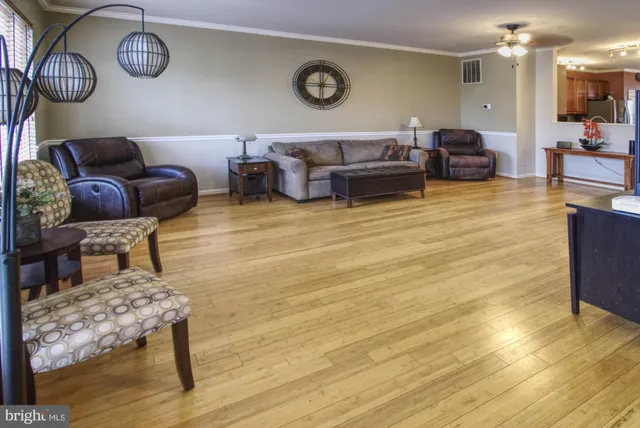 a living room with couch and wooden floor