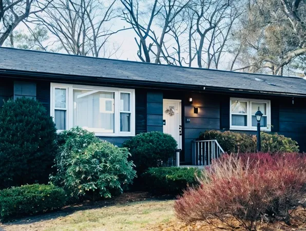 a front view of house and yard with green space