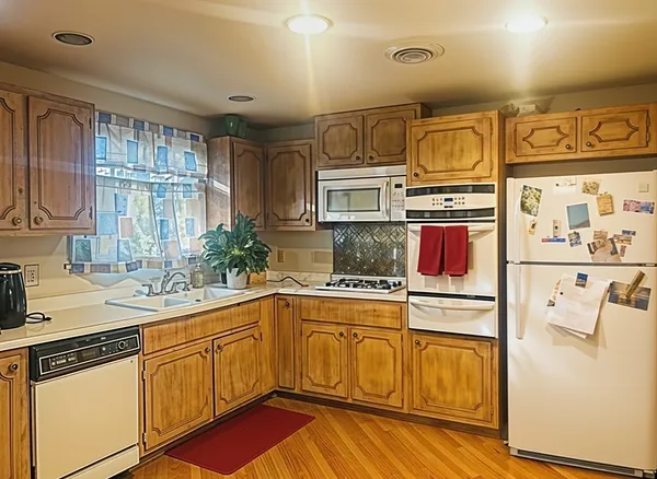 a kitchen with stainless steel appliances a sink stove and cabinets