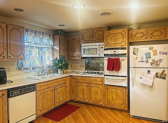 a kitchen with stainless steel appliances a sink stove and cabinets