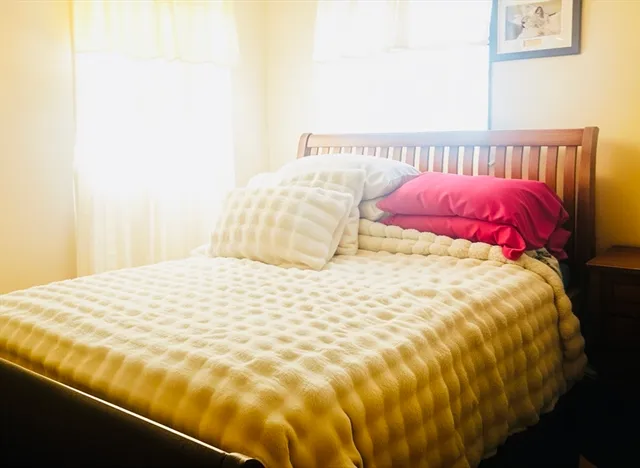 a large bed sitting in a bedroom next to a small yard