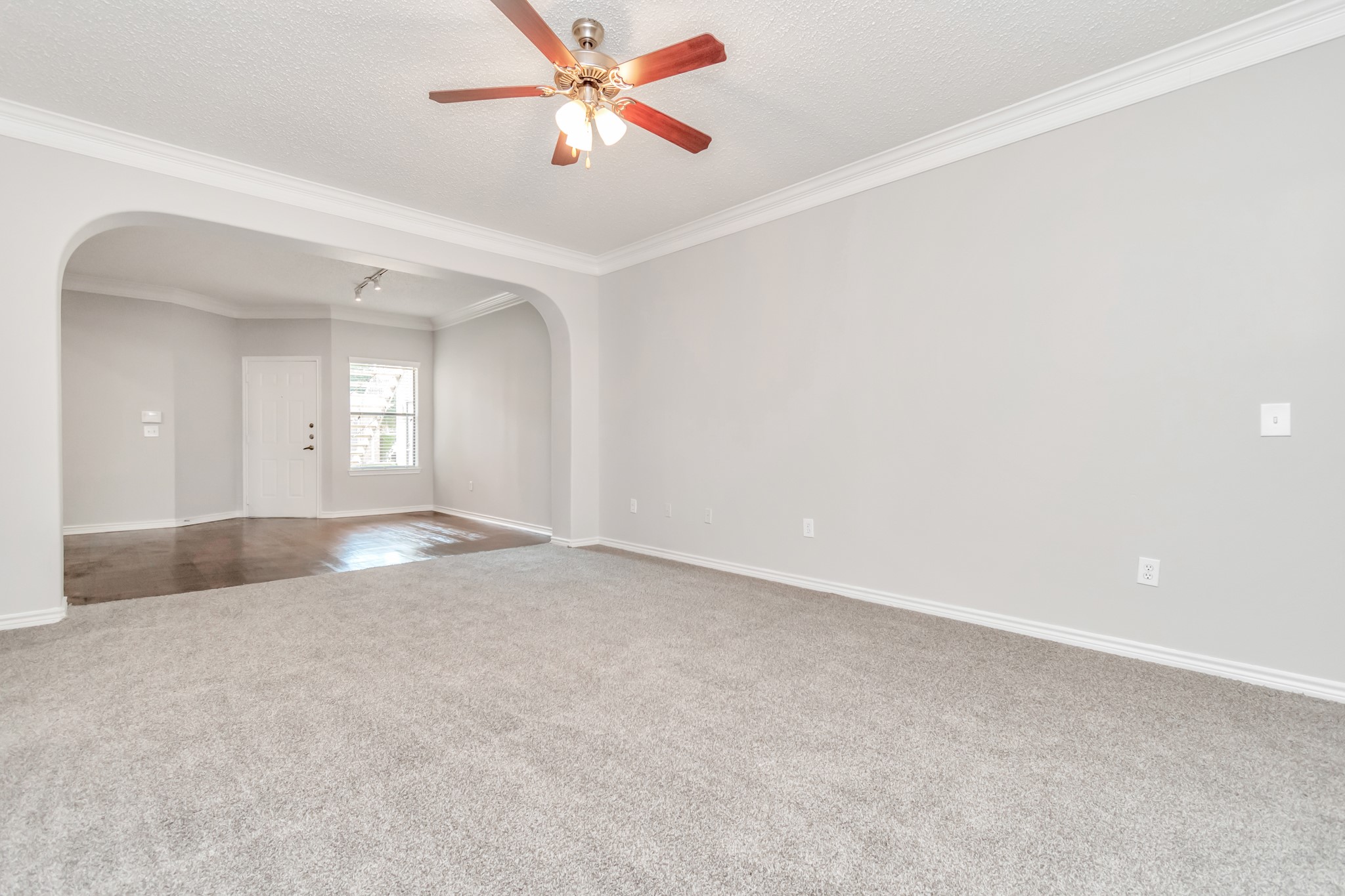 1600 Eldridge Parkway South, Unit 805 Houston, TX 77077 - Photo 17 of 39 an empty room with windows and fan chandelier fan