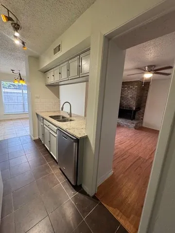 a kitchen with granite countertop a sink and a stove top oven
