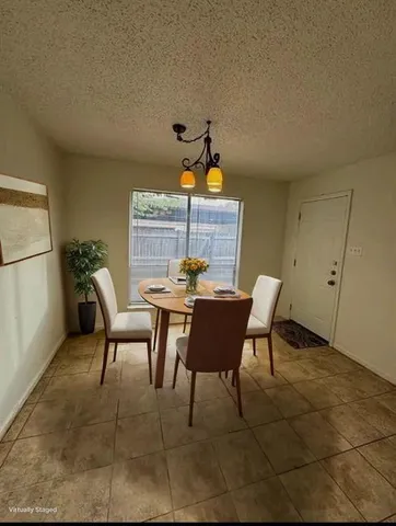 a dining room with furniture and window
