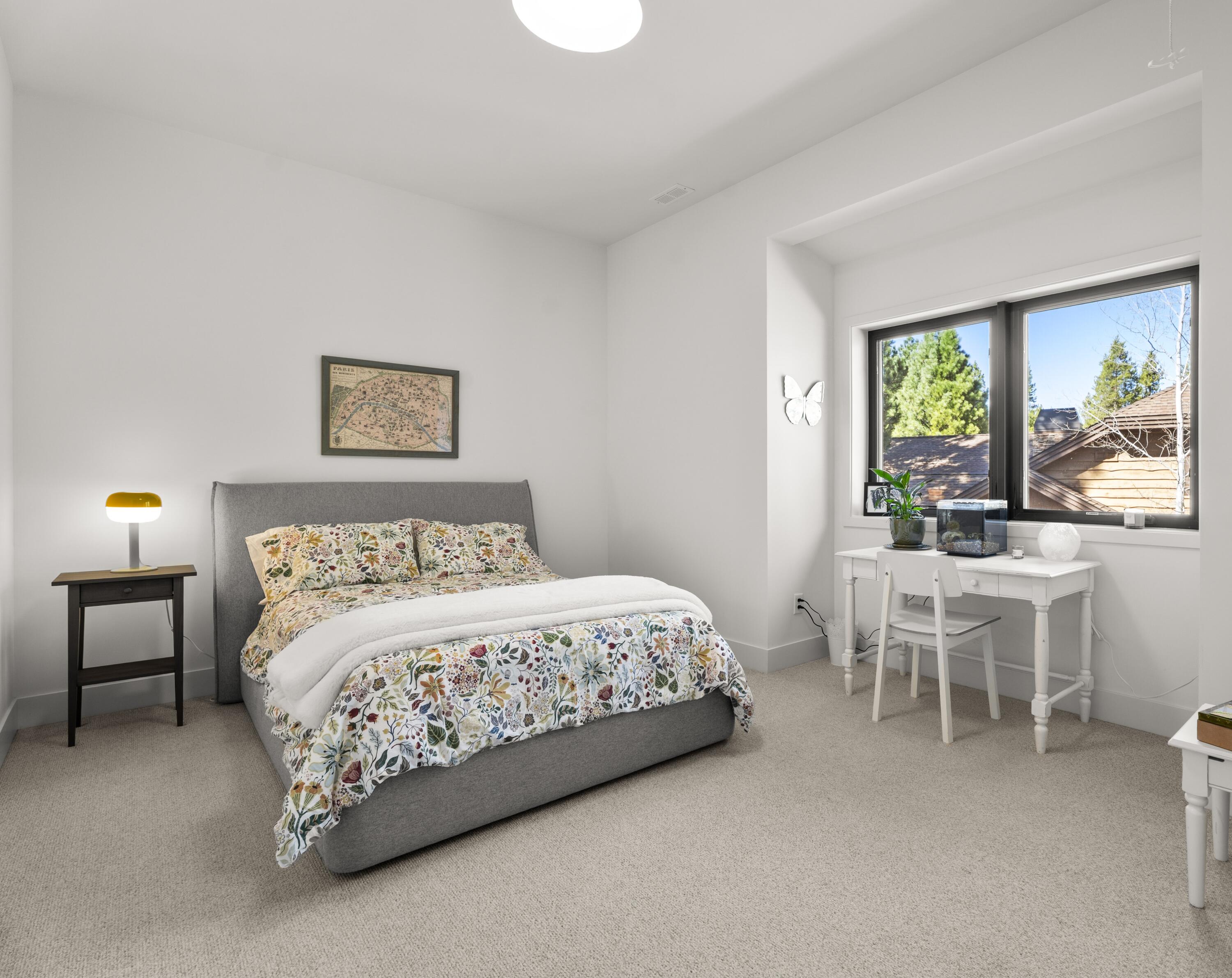 56670 Sunstone Loop, Unit LOT 141 Bend, OR 97707 - Photo 20 of 62 Bright second-level bedroom with soft Hibernia Woolen Mills carpet, clean modern finishes, natural light, and pull-down ladder access to attic storage.