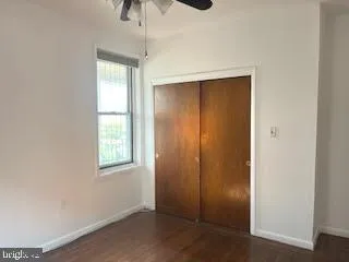 an empty room with windows and closet