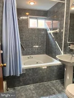 a bathroom with a bathtub and a sink