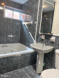 6243 Haverford Avenue, Unit 2 Philadelphia, PA 19151 - Photo 7 of 17 a bathroom with a sink a toilet and bathtub