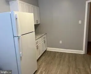 a view of walk in closet with wooden floor