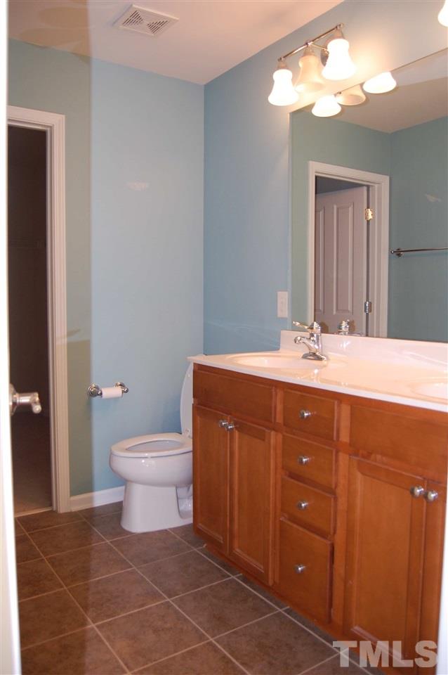 8312 Pilots View Drive Raleigh, NC 27617 - Photo 5 of 10 a bathroom with a sink vanity and a toilet