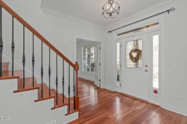 a view of entryway and hall with wooden floor