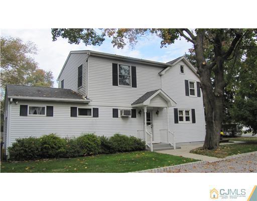 642 Ridge Road Monmouth Junction, NJ 08852 - Photo 4 of 25 a black and white house with a yard