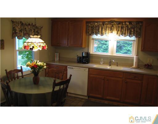 642 Ridge Road Monmouth Junction, NJ 08852 - Photo 8 of 25 a kitchen with a sink cabinets and window