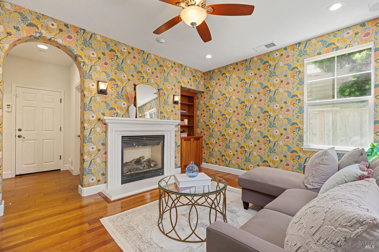 68 Pinheiro Circle Novato, CA 94945 - Photo 22 of 82 The inviting family room features a cozy fireplace, oversized windows, and beautiful backyard views that fill the space with natural light. It's a comfortable gathering place designed for everyday living and relaxed evenings at home.