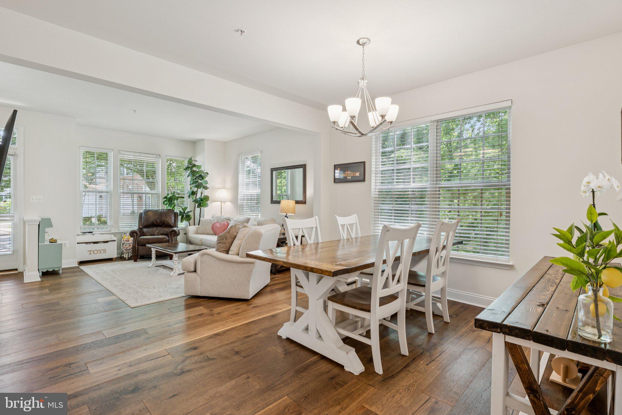856 Stonehurst Drive Annapolis, MD 21409 - Photo 3 of 31 a view of a dining room with furniture a chandelier and wooden floor