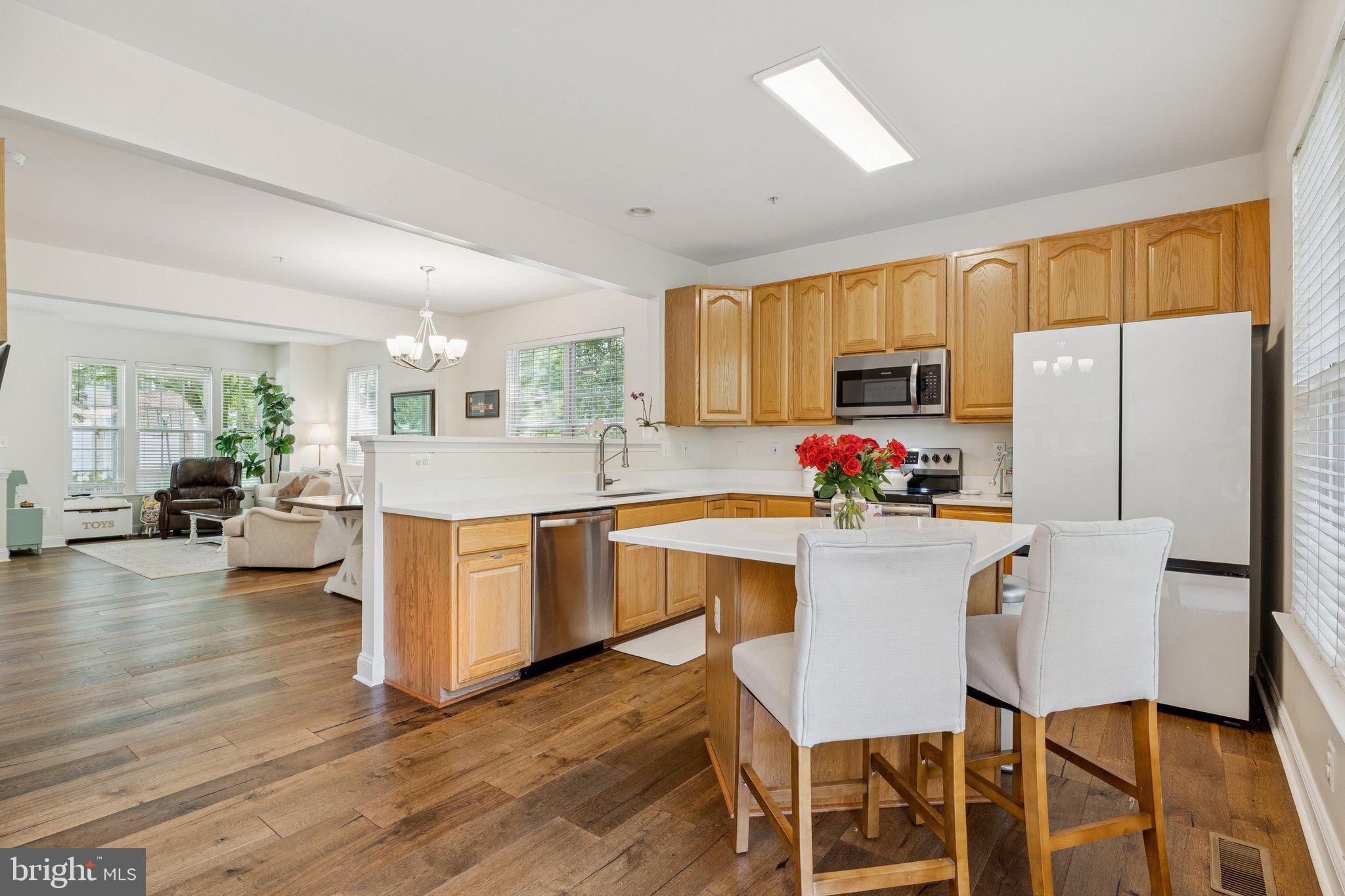856 Stonehurst Drive Annapolis, MD 21409 - Photo 6 of 31 a kitchen with stainless steel appliances granite countertop a refrigerator a stove top oven a sink dishwasher and white cabinets with wooden floor