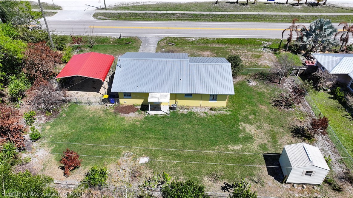 3303 Lakewood Road Sebring, FL 33875 - Photo 13 of 34 a aerial view of a house with a garden and lake view