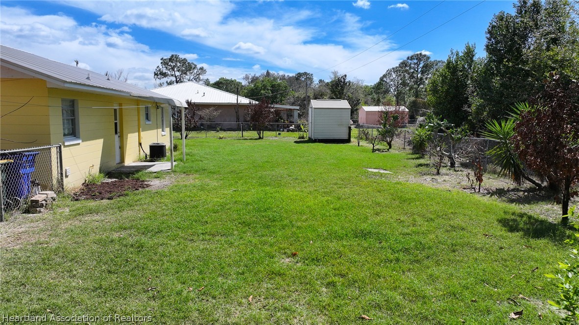 3303 Lakewood Road Sebring, FL 33875 - Photo 18 of 34 a view of a house with backyard and sitting area