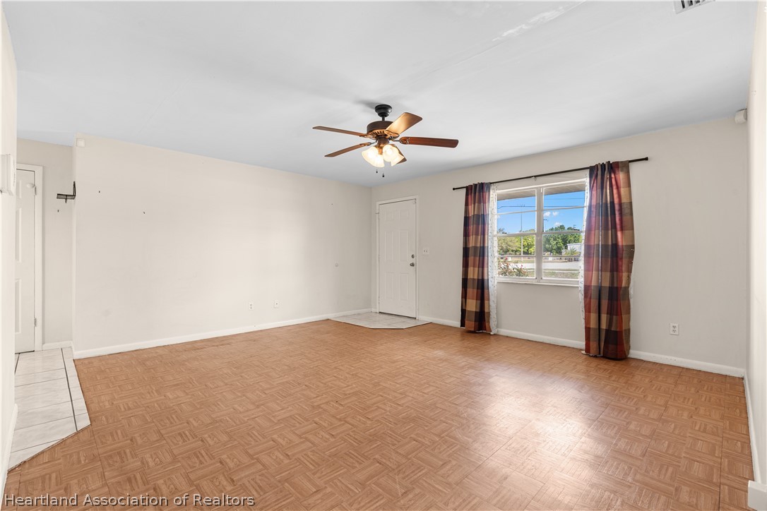 3303 Lakewood Road Sebring, FL 33875 - Photo 20 of 34 a view of a room with a ceiling fan and hardwood floor
