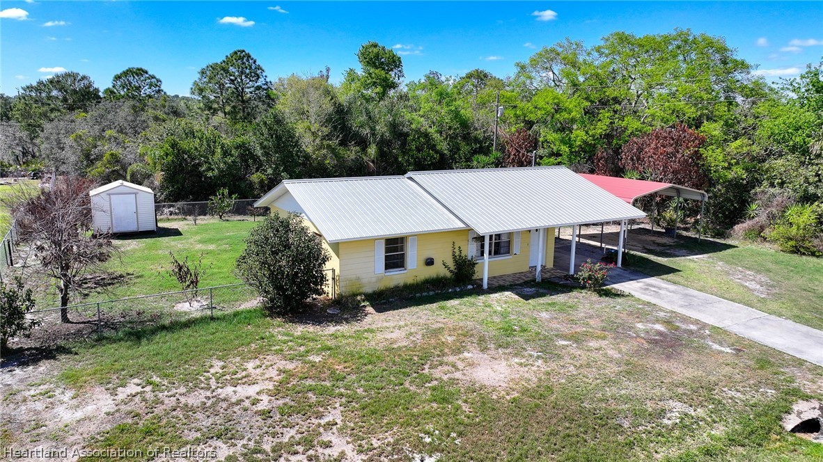 3303 Lakewood Road Sebring, FL 33875 - Photo 2 of 34 an aerial view of a house having yard