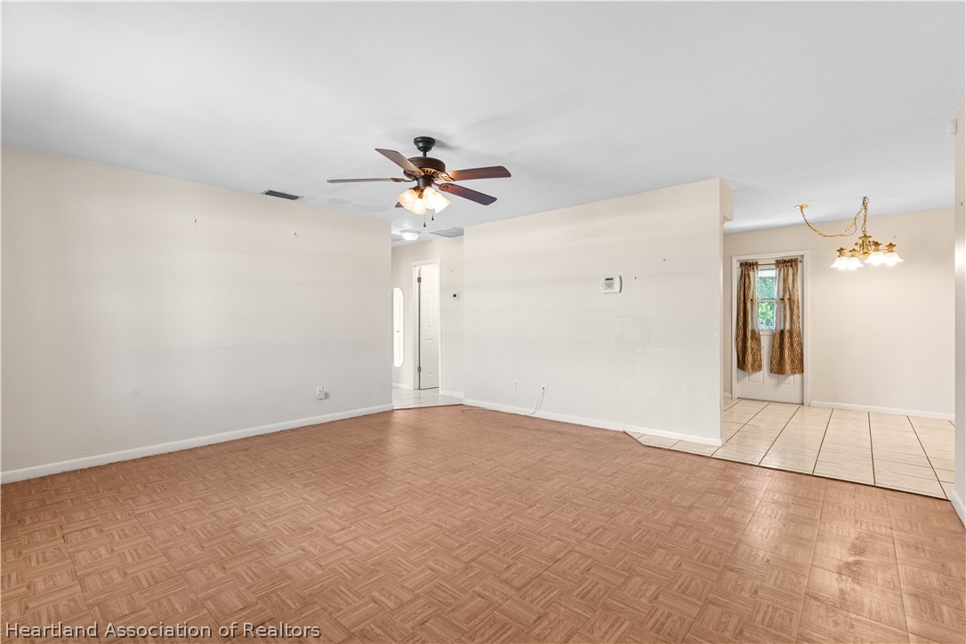 3303 Lakewood Road Sebring, FL 33875 - Photo 22 of 34 a view of an empty room with a chandelier fan