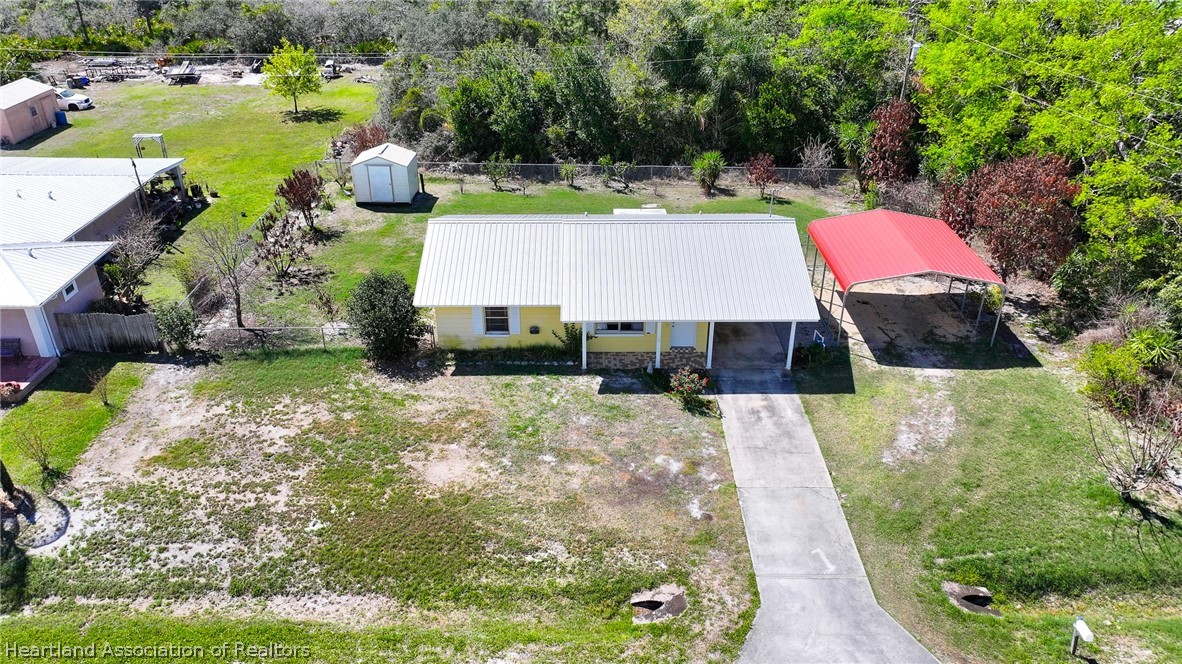 3303 Lakewood Road Sebring, FL 33875 - Photo 3 of 34 an aerial view of a house with yard swimming pool and outdoor seating