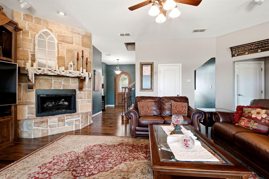 600 Aspen Street Pilot Point, TX 76258 - Photo 5 of 39 Stone-clad fireplace with a wood mantle, wood-finish flooring, and recessed lighting