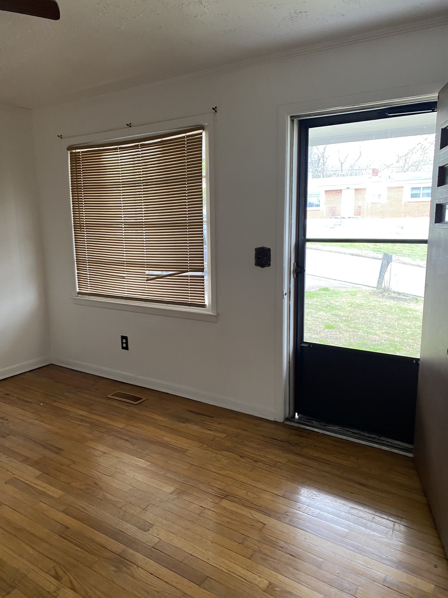 1035 North 3rd Street Pulaski, TN 38478 - Photo 5 of 17 a view of an empty room with wooden floor and a window