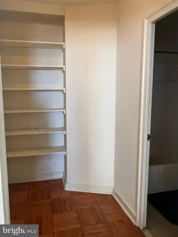 a view of walk in closet with empty racks