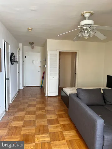 a living room with a couch and chandelier
