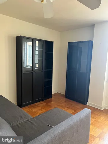 a blue bed sitting in a room next to a window