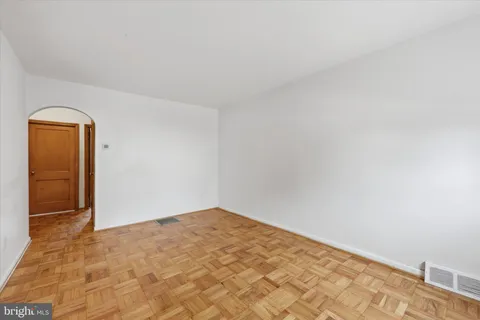 a view of a kitchen with wooden floor and electronic appliances