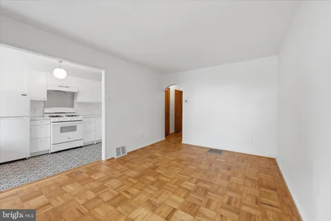 an empty room with a bathroom and a window