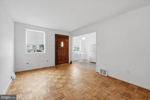 a kitchen with stainless steel appliances granite countertop a refrigerator a sink a stove and white cabinets