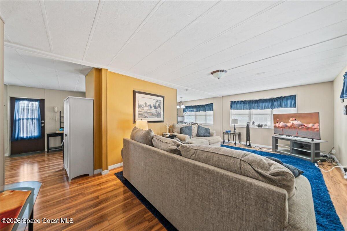 1740 Seagrape Street Northeast Palm Bay, FL 32905 - Photo 4 of 33 a living room with furniture and a wooden floor