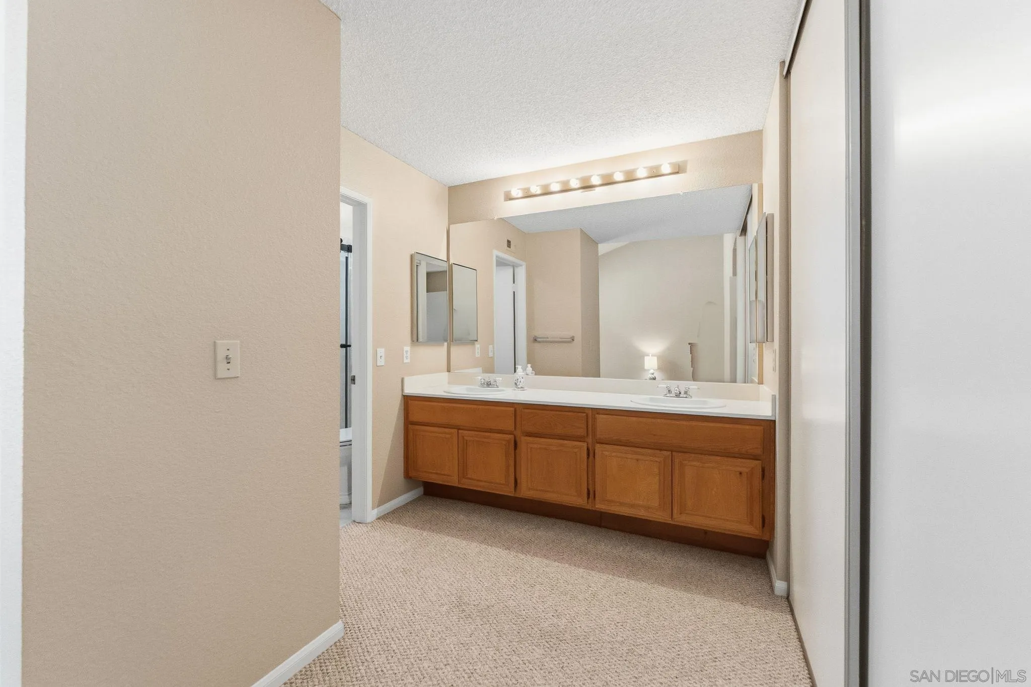 10565 Strathmore Drive Santee, CA 92071 - Photo 30 of 59 a spacious bathroom with a double vanity sink and a mirror