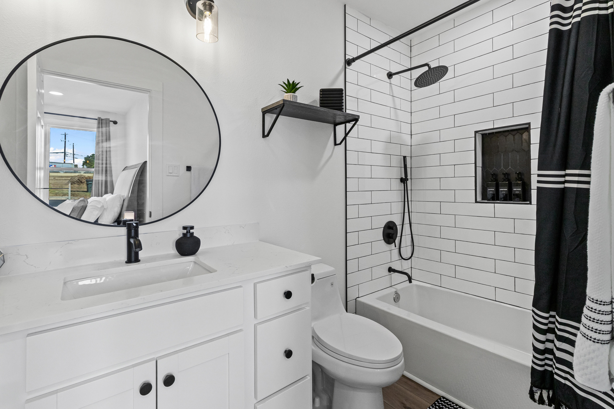 901 North Church Street Georgetown, TX 78626 - Photo 22 of 32 Bathroom with vanity, shower / bath combination with curtain, and dark wood-type flooring