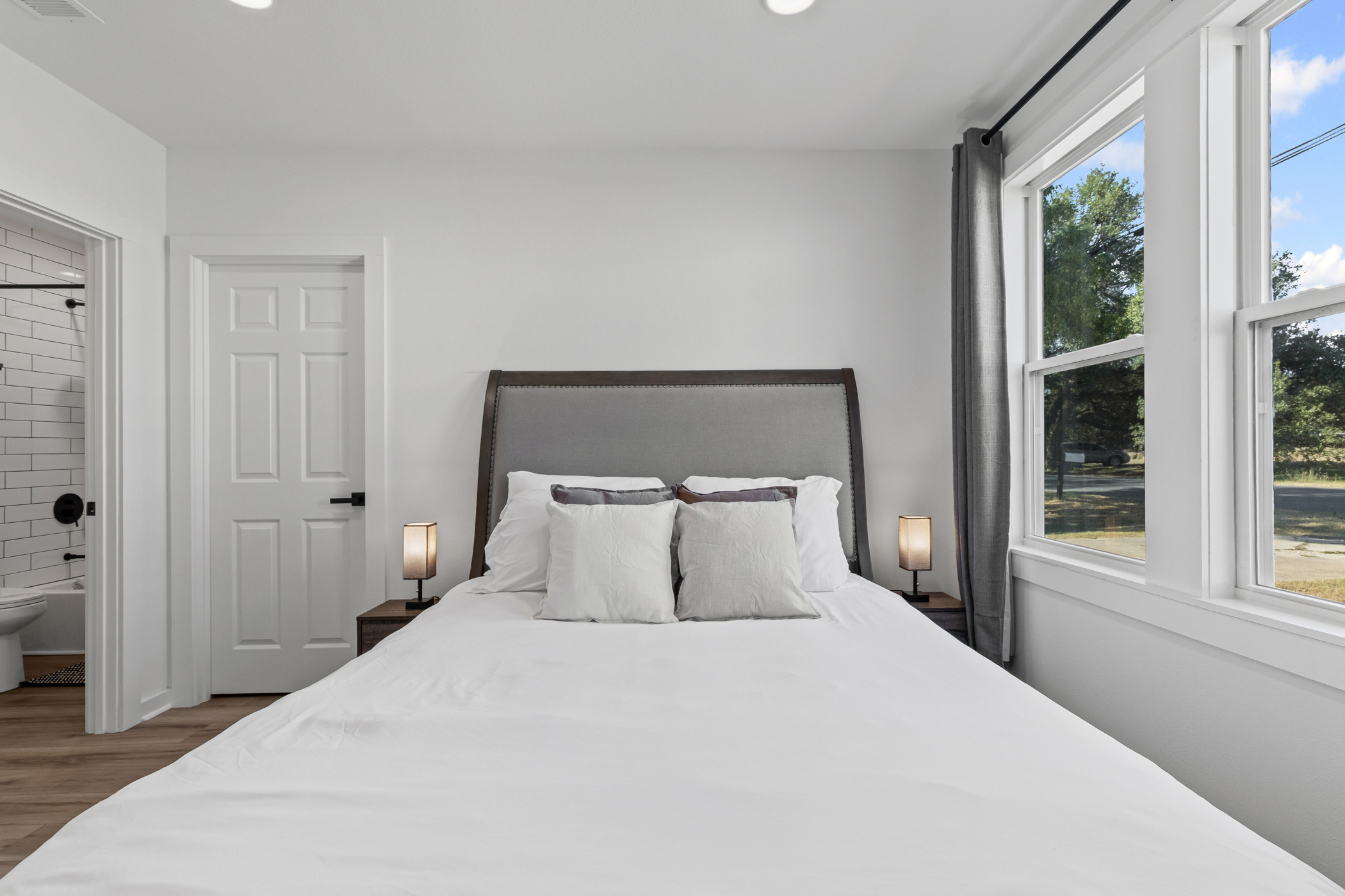 901 North Church Street Georgetown, TX 78626 - Photo 26 of 32 Bedroom with recessed lighting, wood finished floors, and ensuite bathroom