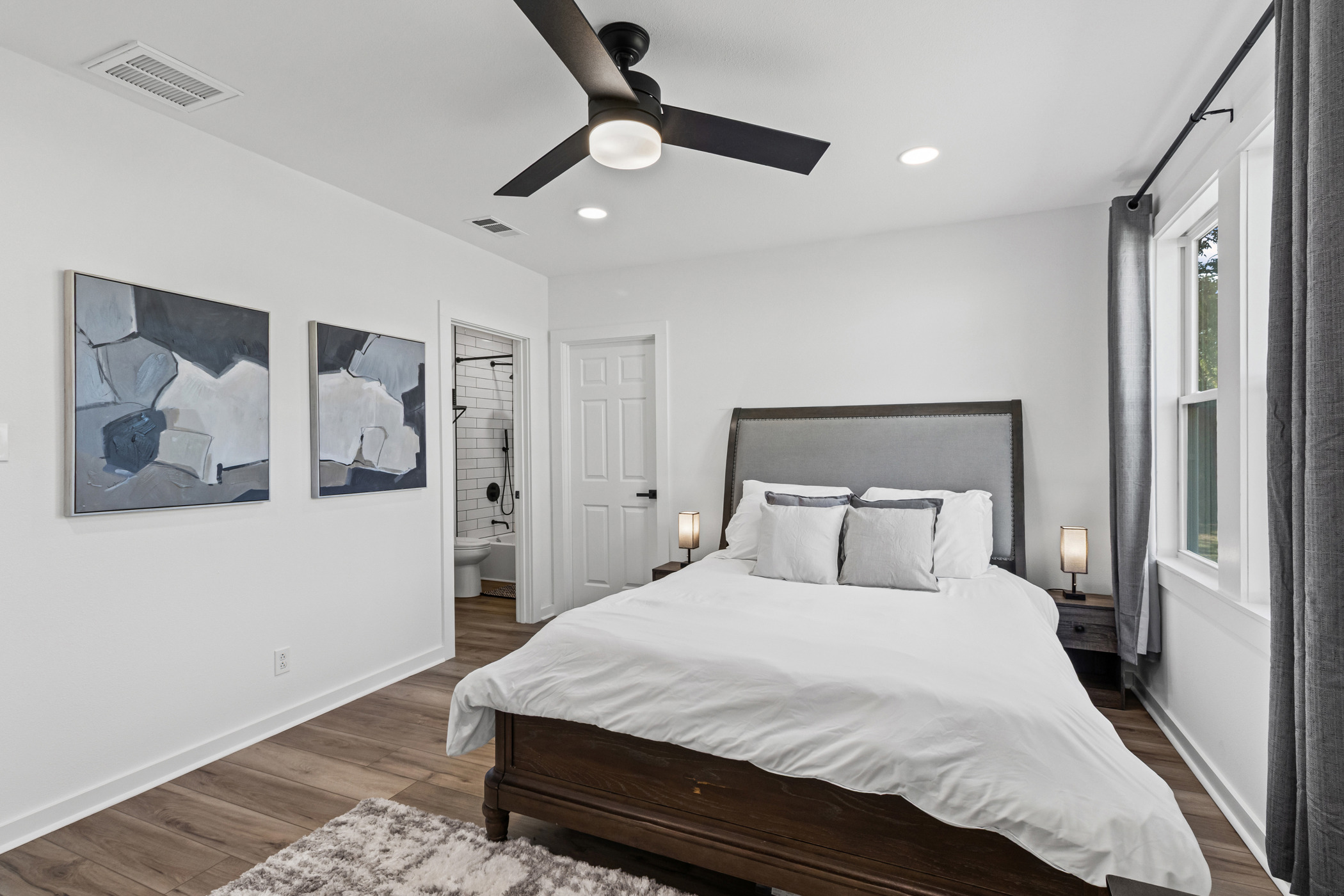901 North Church Street Georgetown, TX 78626 - Photo 28 of 32 Bedroom with connected bathroom, wood finished floors, ceiling fan, and recessed lighting