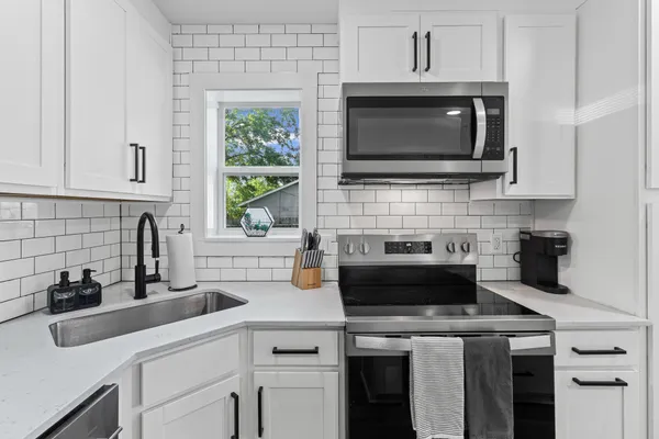 a kitchen with a stove and a microwave