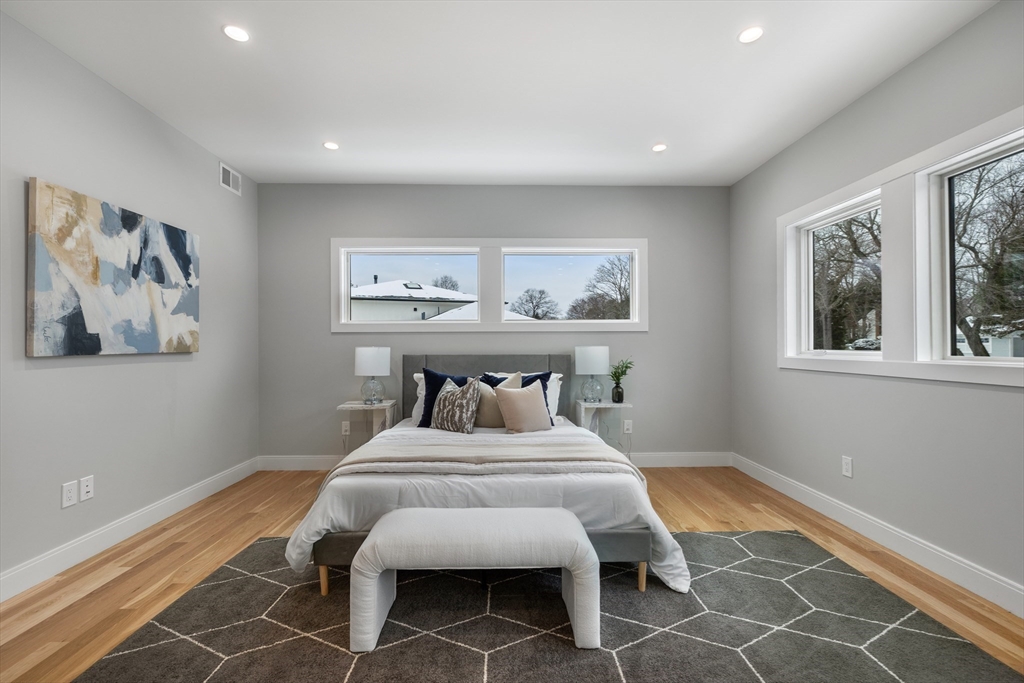 68 Longmeadow Road Belmont, MA 02478 - Photo 22 of 39 a bedroom with a bed and a painting on the wall