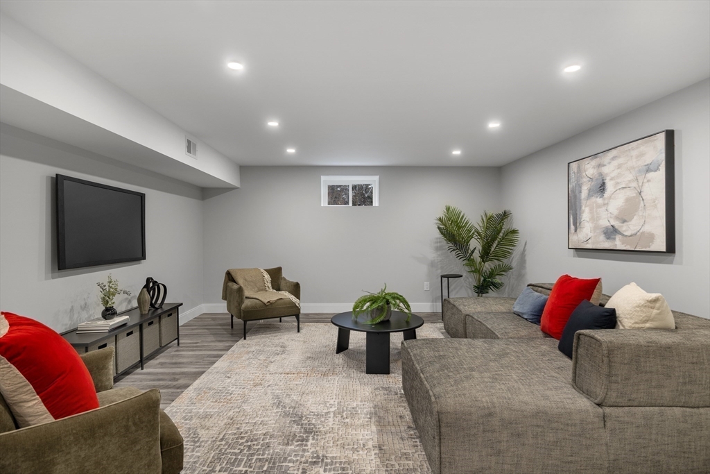 68 Longmeadow Road Belmont, MA 02478 - Photo 27 of 39 a living room with furniture and a flat screen tv