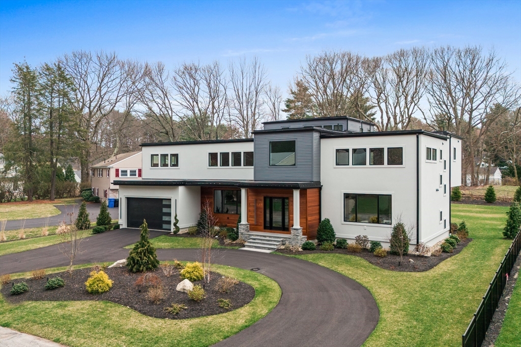 68 Longmeadow Road Belmont, MA 02478 - Photo 31 of 39 a view of a white house with a yard garden and outdoor seating