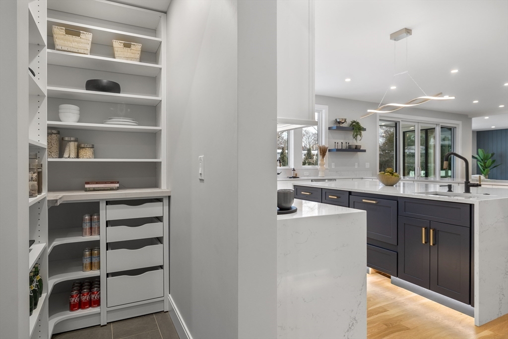 68 Longmeadow Road Belmont, MA 02478 - Photo 5 of 39 a kitchen with a refrigerator and cabinets