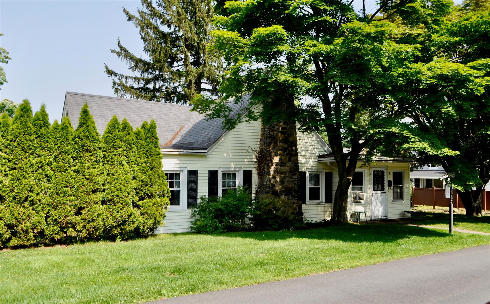 5 Orchard Drive Rye, NY 10580 - Photo 1 of 1 a front view of a house with a garden