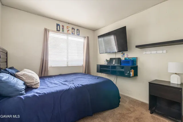 a bedroom with a bed furniture and a window